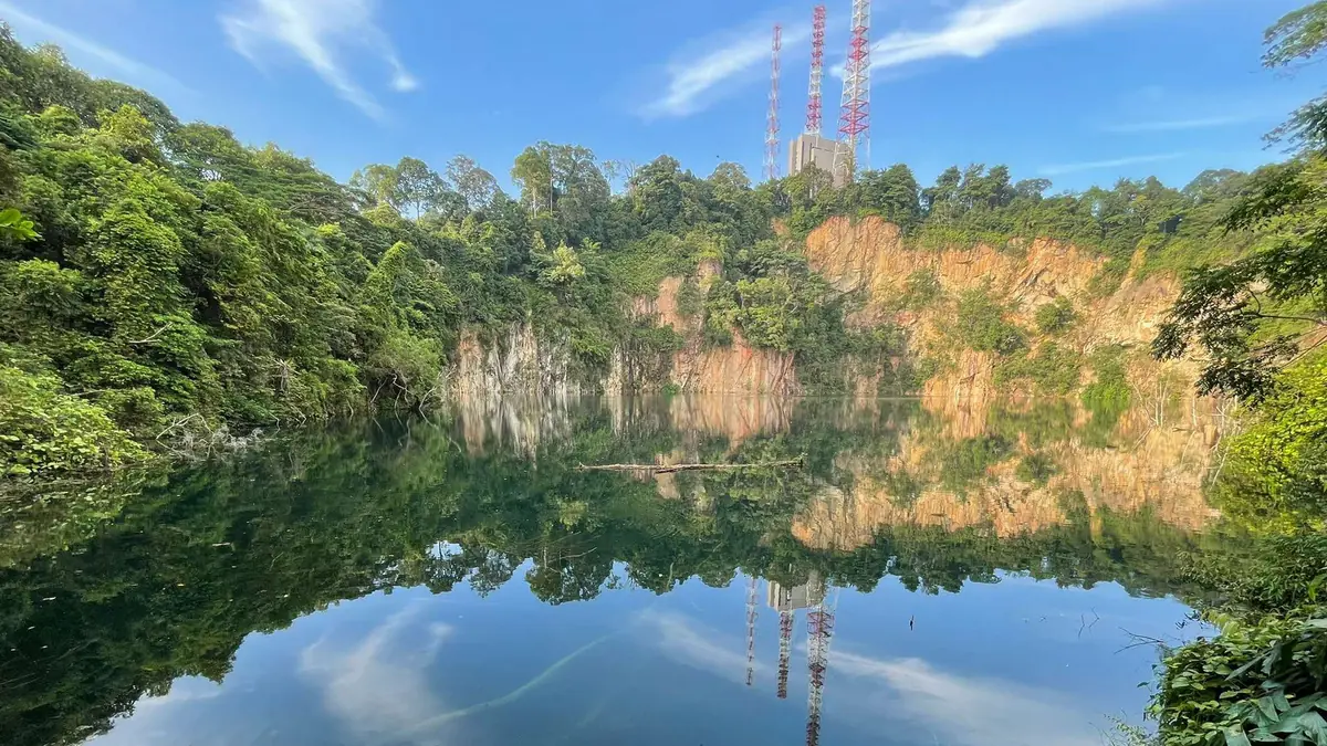 Bukit Timah Nature Reserve — The turquoise water of Hindhede Quarry inside Bukit Timah Nature Reserve, Singapore, ringed by rainforest