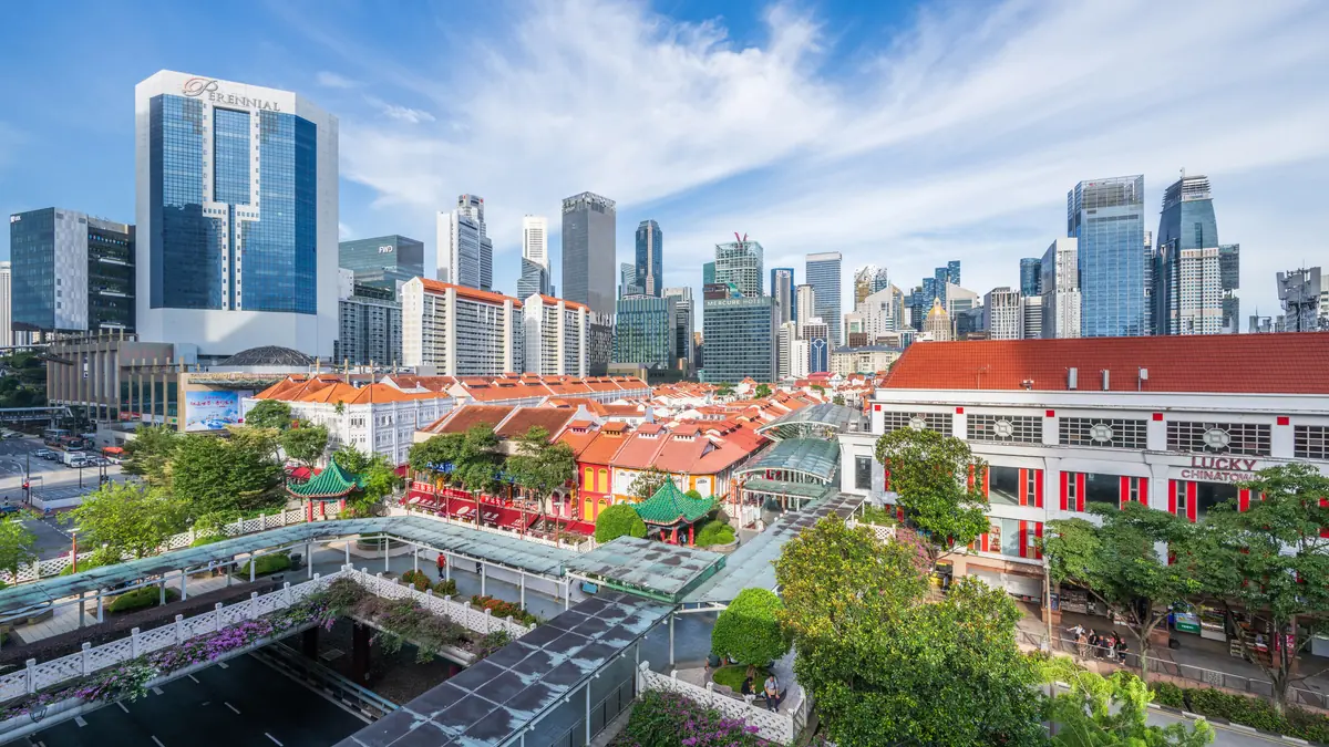 Chinatown — Chinatown's low shophouse rooftops with the Singapore CBD towers rising directly behind them