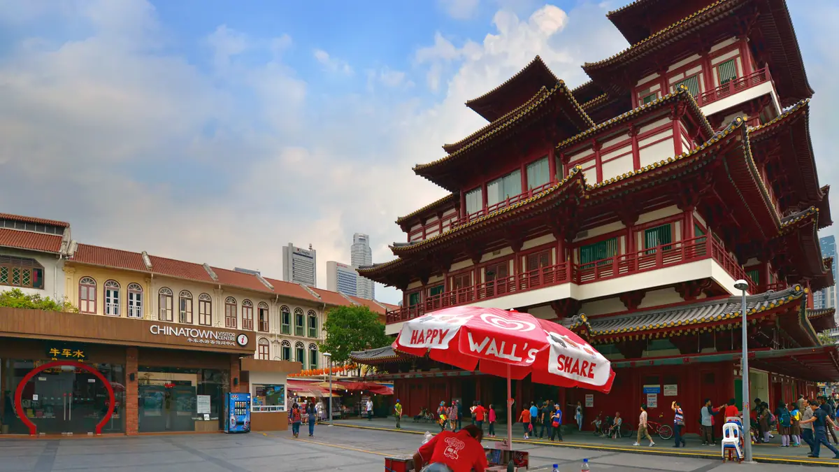 Chinatown — Street level outside the Buddha Tooth Relic Temple and Chinatown Visitor Centre, with an ice cream cart under a red umbrella