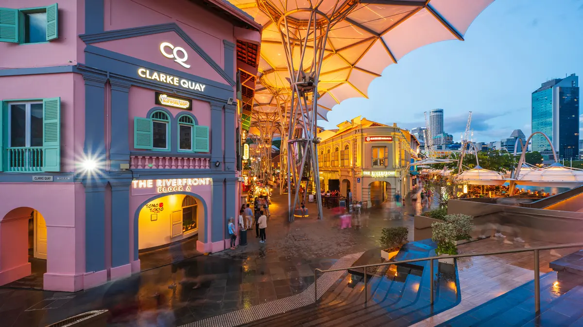 Clarke Quay — Pastel heritage shophouses and the canopy structures of the Clarke Quay precinct at golden hour