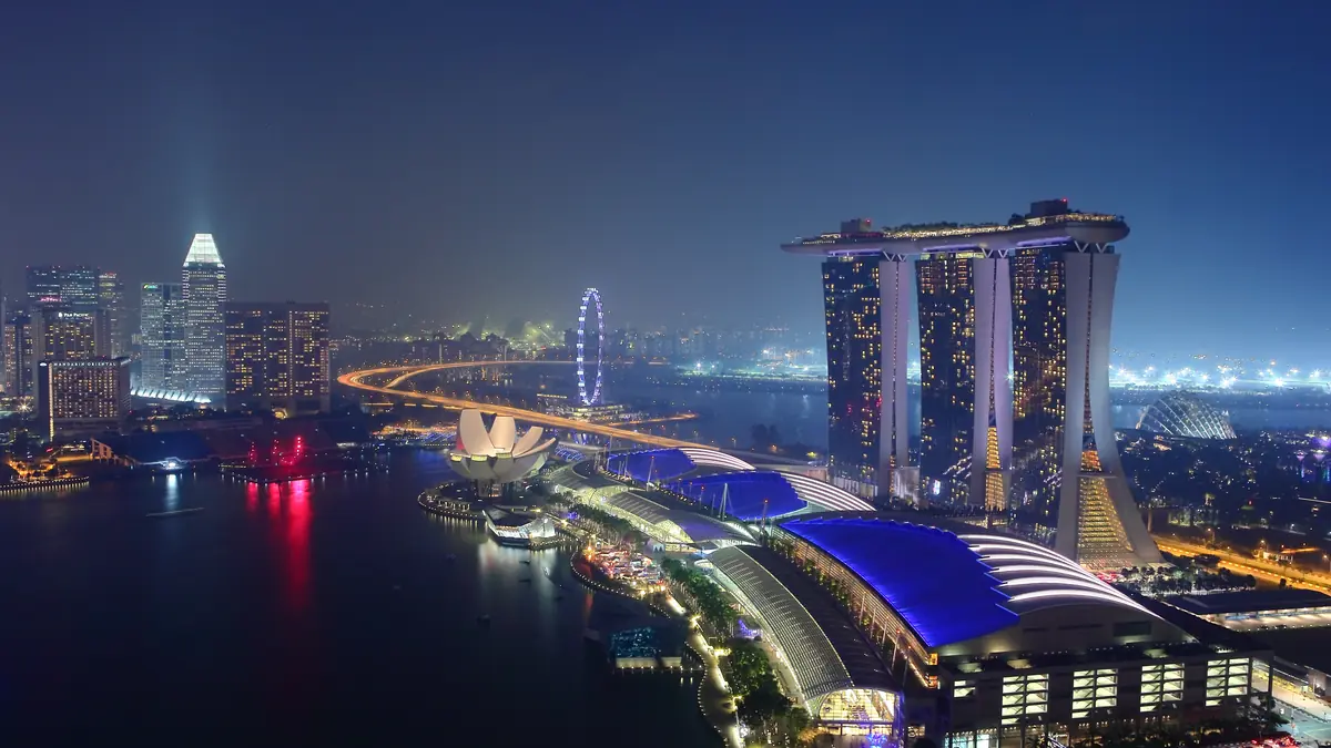 Marina Bay Sands — Night view across Marina Bay with Marina Bay Sands, the ArtScience Museum and the Helix Bridge lit up