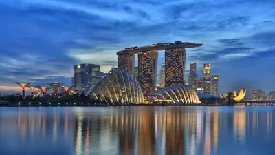 Marina Bay Sands — Marina Bay Sands hotel and the ArtScience Museum lit up at dusk, reflected in Marina Bay