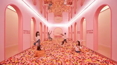 Museum of Ice Cream Singapore — A visitor diving into the giant sprinkle pool at the Museum of Ice Cream Singapore