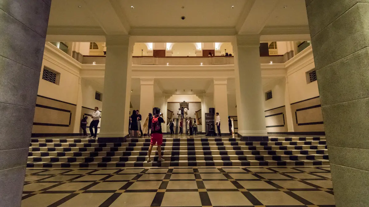 National Gallery Singapore — Visitors on the grand staircase and chequered marble floor inside National Gallery Singapore