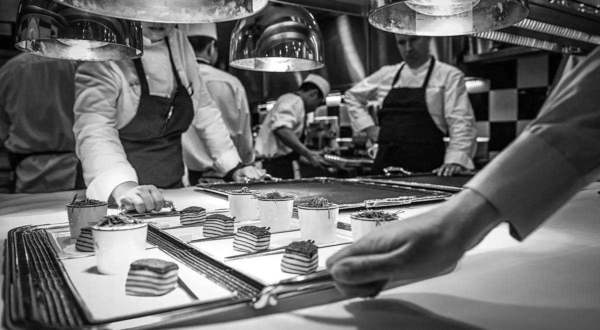 Les Amis pastry team plating desserts at the pass, Singapore