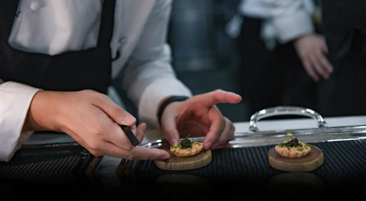Close-up of a canape being finished by hand at Les Amis, Singapore