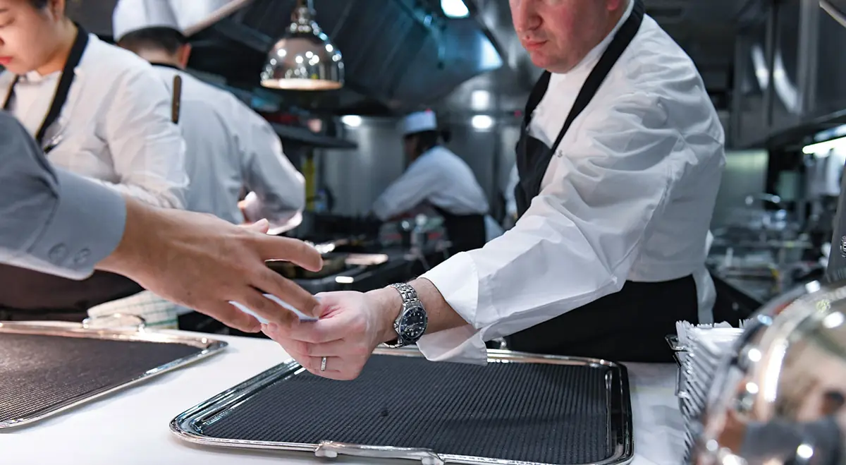 Chefs plating at the pass in the Les Amis kitchen, Singapore