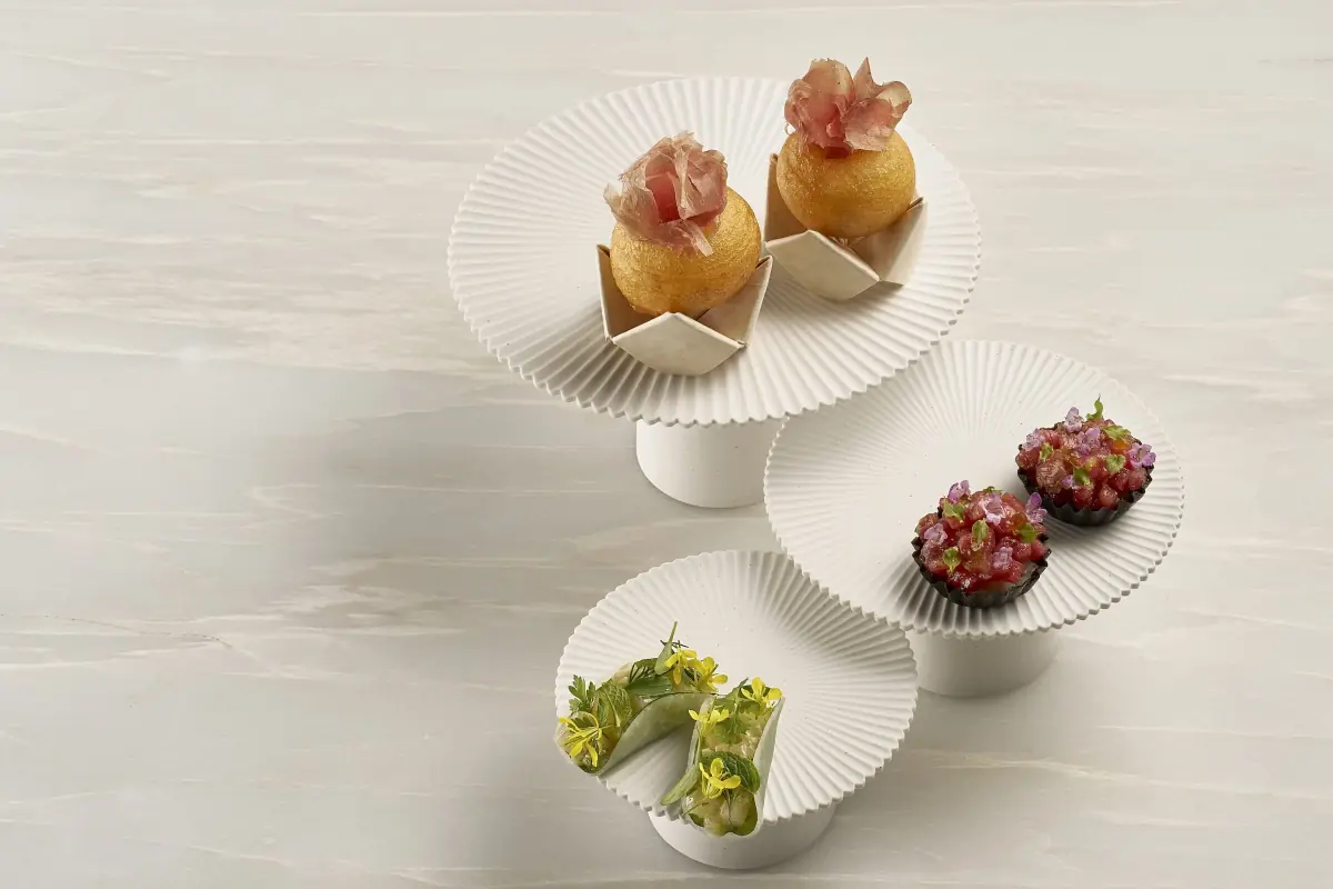 Canapes on white pedestals at Odette, Singapore