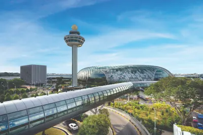 Changi Airport — Changi Airport's control tower rising beside the glass dome of Jewel Changi Airport