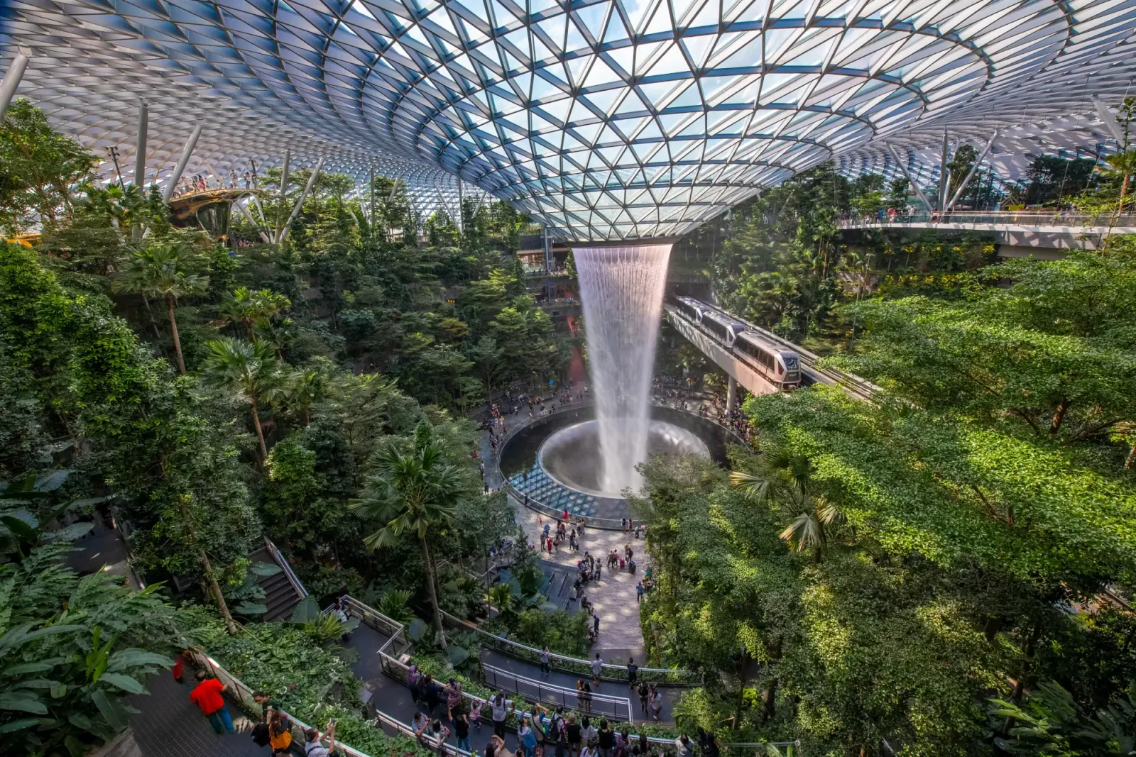 Jewel Changi Airport — Bird's-eye view of the Rain Vortex waterfall and Shiseido Forest Valley planting inside Jewel Changi Airport's glass dome