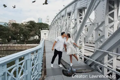 Couple on a waterfront terrace at dusk with the Marina Bay skyline behind, Singapore