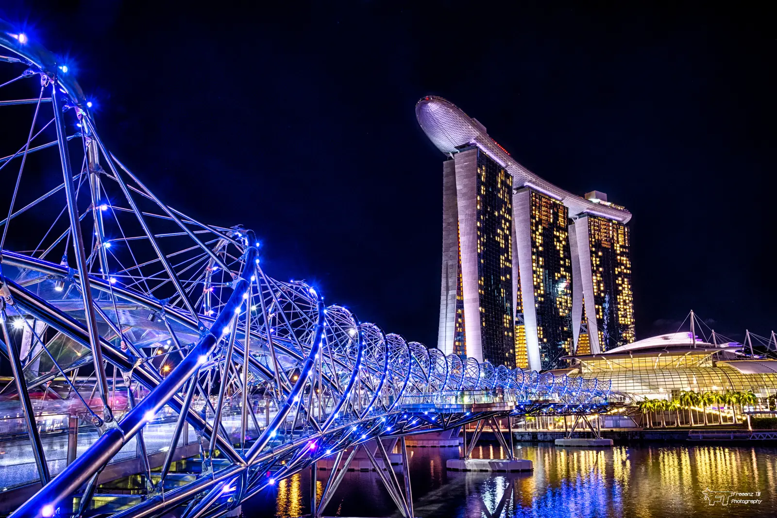 The Helix Bridge lit at night, the walking route between Marina Centre and Marina Bay Sands