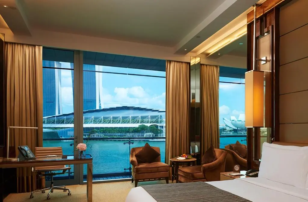 Rooftop pool and Lantern bar at The Fullerton Bay Hotel looking across Marina Bay to Marina Bay Sands