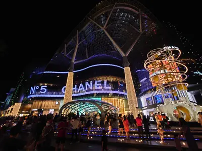 Orchard Road Singapore at dusk, looking down the shopping strip beneath the tree canopy