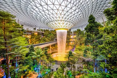 The Rain Vortex indoor waterfall falling through the glass dome at Jewel Changi Airport, Singapore