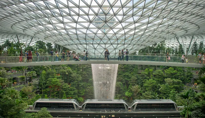 The glass-floored Mastercard Canopy Bridge at Canopy Park, Jewel Changi Airport, looking down on the Rain Vortex